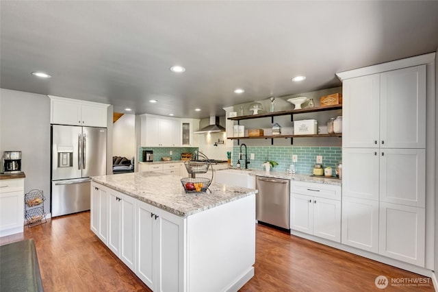 kitchen featuring stainless steel appliances, a sink, tasteful backsplash, white cabinetry, and recessed lighting