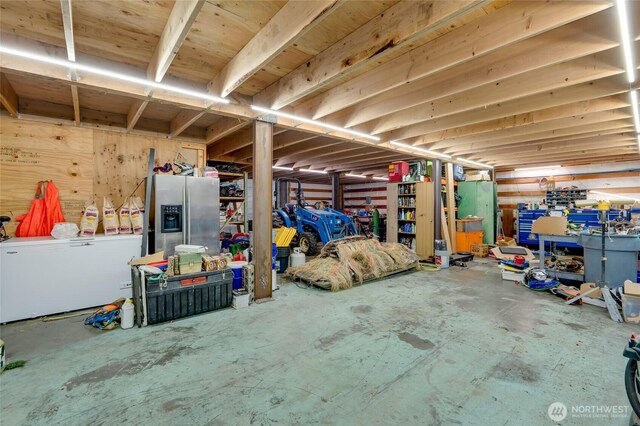 miscellaneous room with concrete floors and a workshop area
