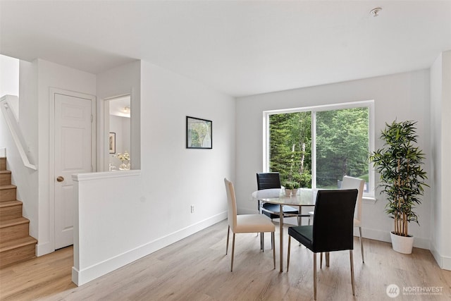 3758 257th Ave SE Unit 4-4, Issaquah, WA 98029 - dining area featuring stairs, light wood-style flooring, and baseboards