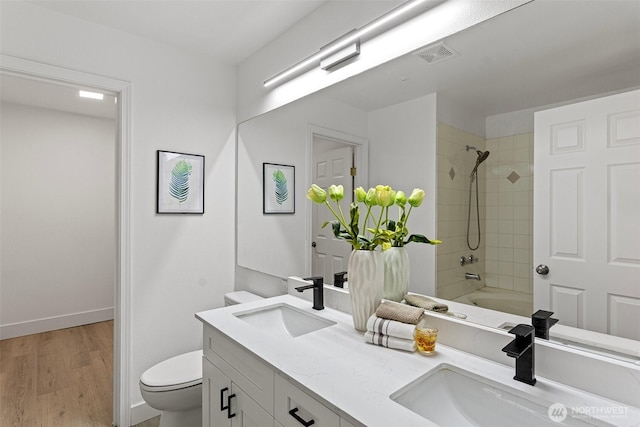 3758 257th Ave SE Unit 4-4, Issaquah, WA 98029 - full bathroom featuring toilet, double vanity, wood finished floors, tub / shower combination, and baseboards