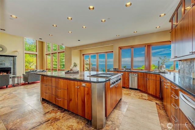 7212 164th St SW, Edmonds, WA 98026 - kitchen featuring stainless steel gas stovetop, recessed lighting, a warming drawer, a fireplace, and a center island