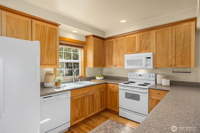 kitchen featuring a sink, white appliances, brown cabinets, recessed lighting, and light wood-style flooring