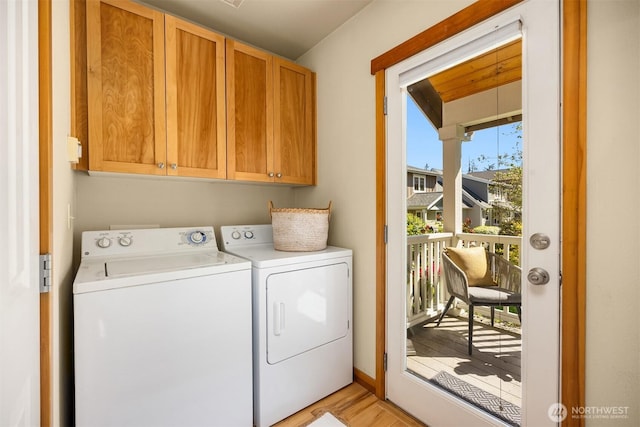 laundry area with washer and clothes dryer, cabinet space, and light wood-type flooring