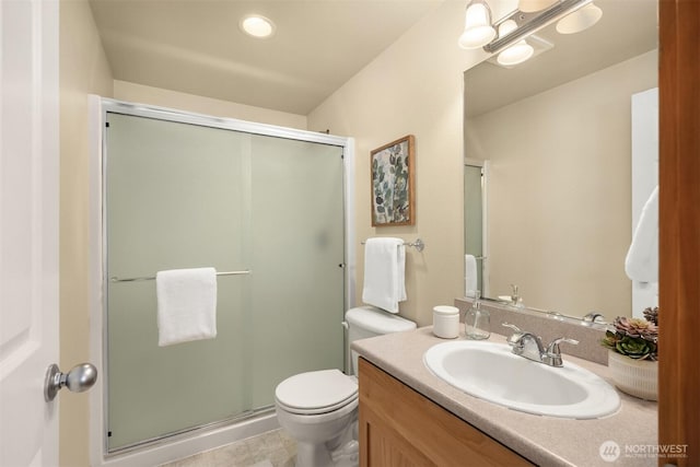 full bathroom featuring vanity, toilet, and a shower stall