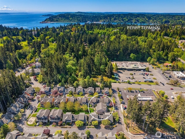 aerial view with a water view, a forest view, and a residential view