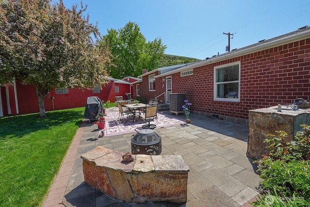 201 S Cherry St, Dayton, WA 99328 - view of patio / terrace featuring an outdoor fire pit and central AC