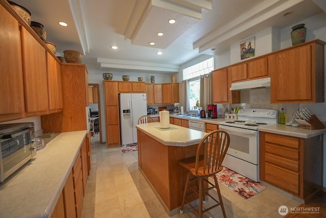 201 S Cherry St, Dayton, WA 99328 - kitchen featuring white appliances, recessed lighting, under cabinet range hood, and a center island