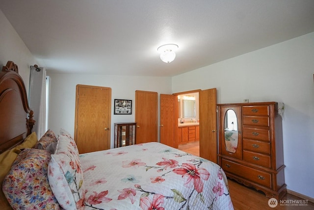 201 S Cherry St, Dayton, WA 99328 - bedroom with connected bathroom and light wood-style flooring