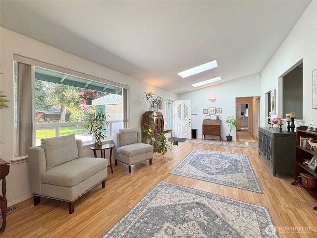 401 Dungeness Mdws, Sequim, WA 98382 - sitting room with a skylight, vaulted ceiling, and light wood-style floors