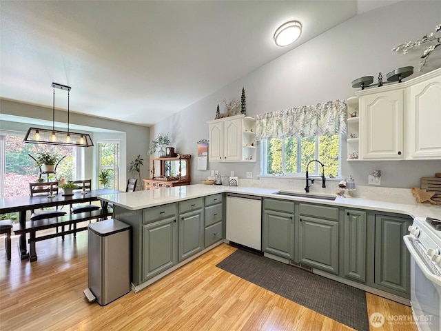 401 Dungeness Mdws, Sequim, WA 98382 - kitchen featuring white dishwasher, open shelves, a sink, gray cabinets, and a peninsula