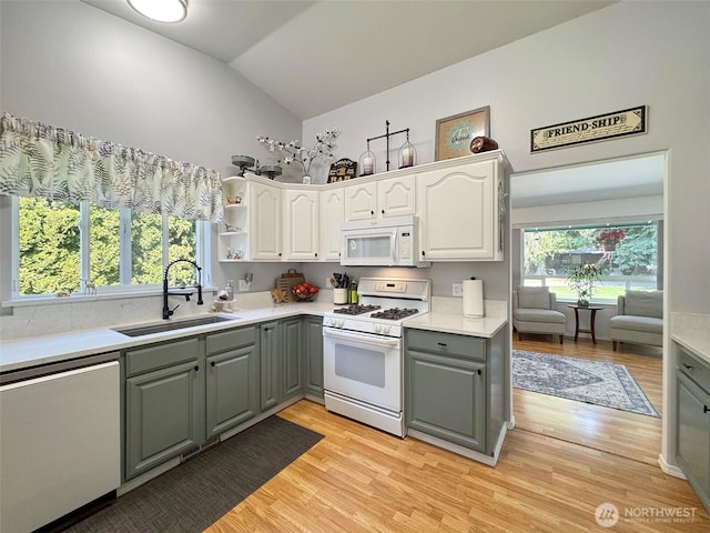401 Dungeness Mdws, Sequim, WA 98382 - kitchen with white appliances, gray cabinetry, a sink, lofted ceiling, and light wood finished floors