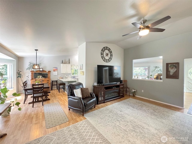 401 Dungeness Mdws, Sequim, WA 98382 - living room with light wood-style flooring, ceiling fan, baseboards, and lofted ceiling