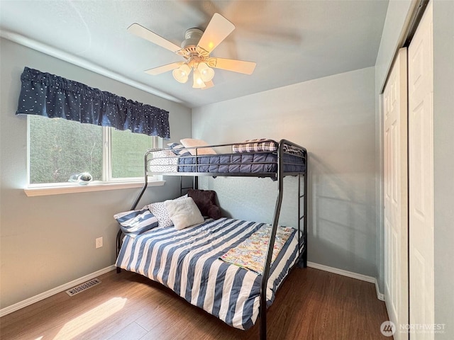 401 Dungeness Mdws, Sequim, WA 98382 - bedroom with wood finished floors, baseboards, ceiling fan, and a closet