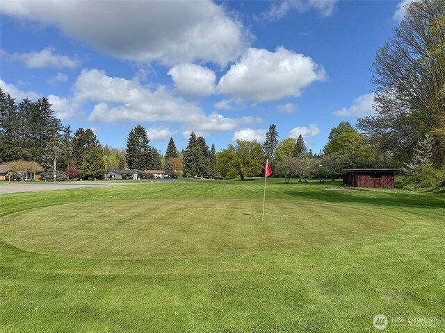 401 Dungeness Mdws, Sequim, WA 98382 - surrounding community with view of golf course, view of scattered trees, and a lawn