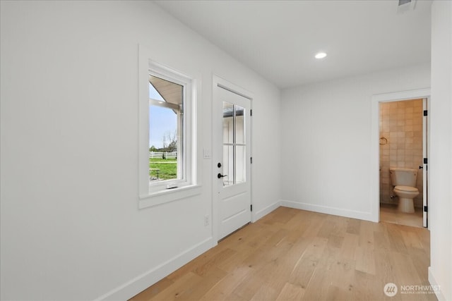 doorway with light wood-style flooring, baseboards, and recessed lighting