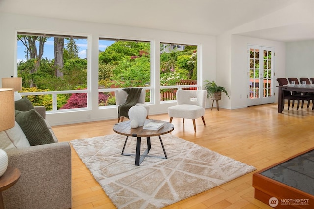 sunroom featuring french doors and vaulted ceiling