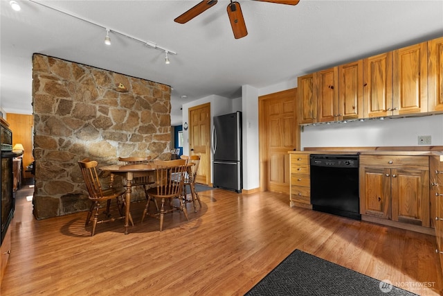 69 Ross Rd, Twisp, WA 98856 - kitchen with freestanding refrigerator, dishwasher, a ceiling fan, light wood-style floors, and brown cabinetry