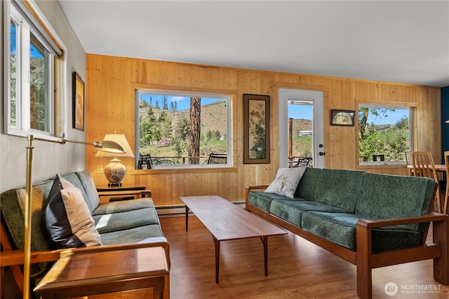 69 Ross Rd, Twisp, WA 98856 - living area featuring a baseboard radiator, wooden walls, and wood finished floors