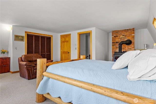 69 Ross Rd, Twisp, WA 98856 - bedroom featuring a wood stove, a closet, and carpet floors