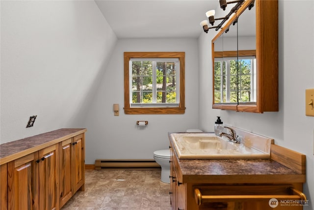 69 Ross Rd, Twisp, WA 98856 - bathroom featuring a baseboard radiator, plenty of natural light, toilet, and vanity