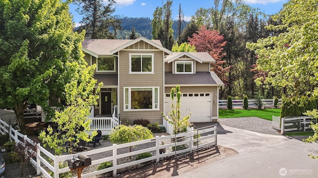 545 SE Lewis St, Issaquah, WA 98027 - view of front of home with fence, a garage, a shingled roof, and driveway