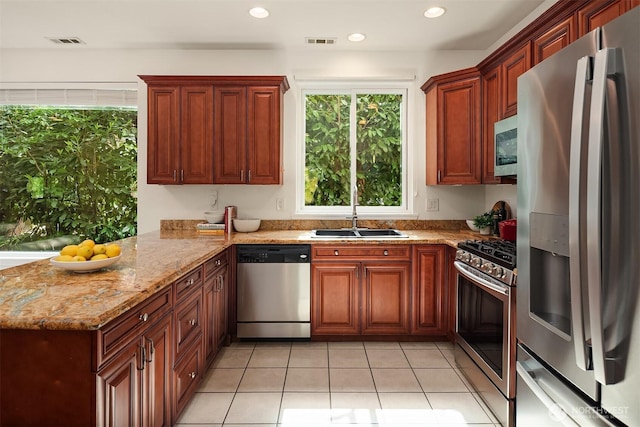 545 SE Lewis St, Issaquah, WA 98027 - kitchen with a sink, a peninsula, visible vents, light tile patterned floors, and appliances with stainless steel finishes