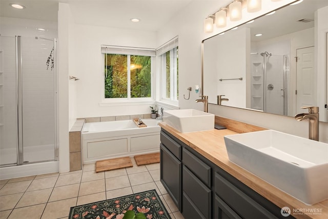 545 SE Lewis St, Issaquah, WA 98027 - bathroom with a shower stall, tile patterned flooring, visible vents, and a sink