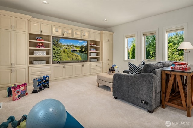 living area with light colored carpet and recessed lighting