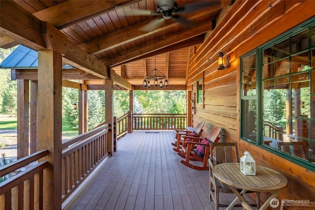 wooden terrace with covered porch and a ceiling fan