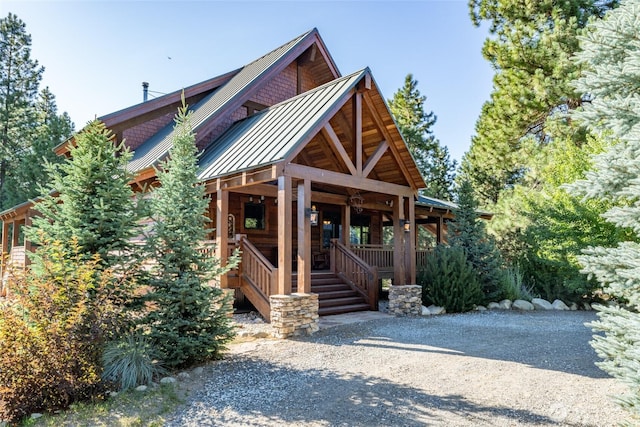 view of front of home featuring covered porch, metal roof, and a standing seam roof