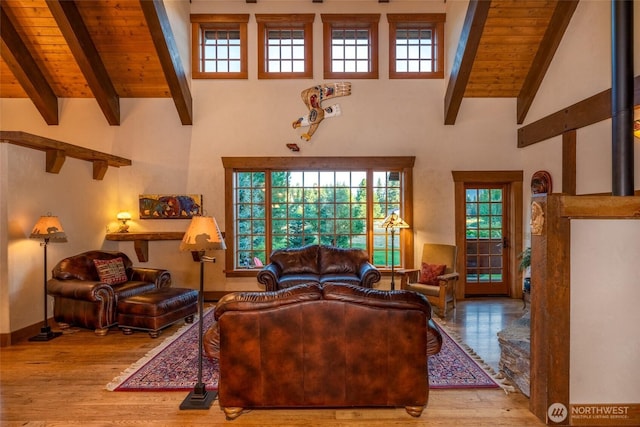 living area with wood finished floors, wood ceiling, and beam ceiling