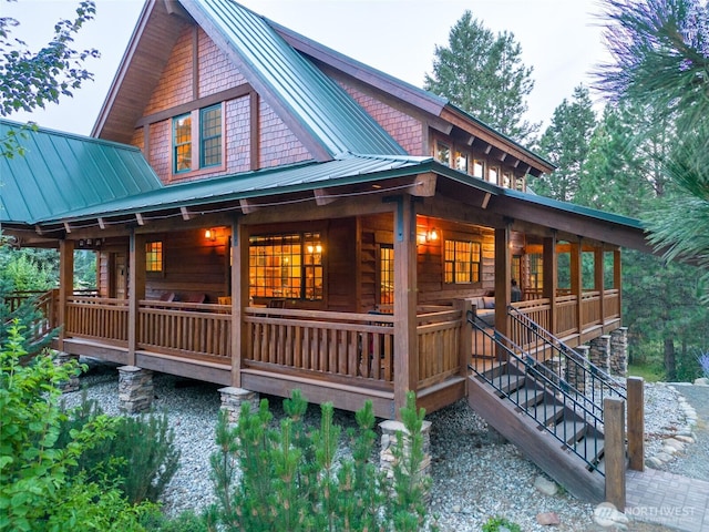 exterior space with a porch, metal roof, and a standing seam roof