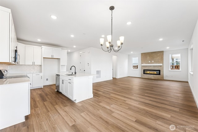 20336 150th St E Unit 588, Bonney Lake, WA 98391 - kitchen with stainless steel appliances, a sink, open floor plan, light wood-style floors, and recessed lighting