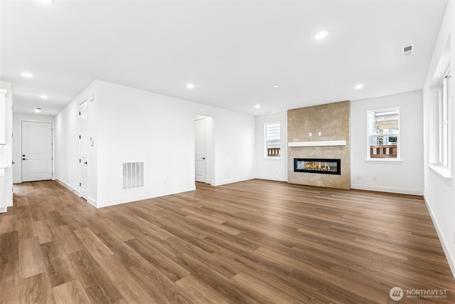 20336 150th St E Unit 588, Bonney Lake, WA 98391 - unfurnished living room with wood finished floors, healthy amount of natural light, baseboards, and recessed lighting
