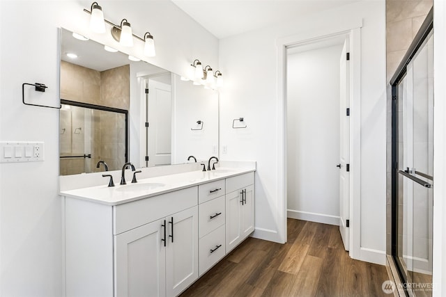 20336 150th St E Unit 588, Bonney Lake, WA 98391 - full bathroom featuring double vanity, a stall shower, wood finished floors, and baseboards