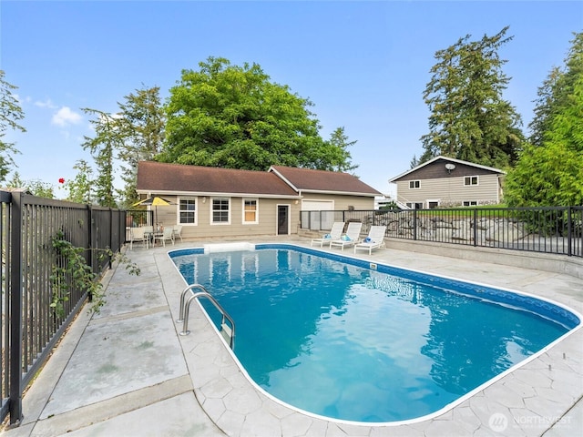 21608 186th Ave E, Orting, WA 98360 - view of swimming pool featuring a patio area, fence, and an outbuilding