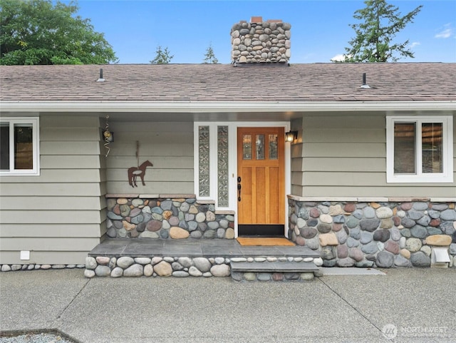 21608 186th Ave E, Orting, WA 98360 - doorway to property with a chimney, a shingled roof, stone siding, and a porch