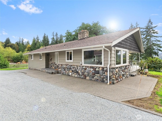21608 186th Ave E, Orting, WA 98360 - ranch-style home featuring a chimney and stone siding