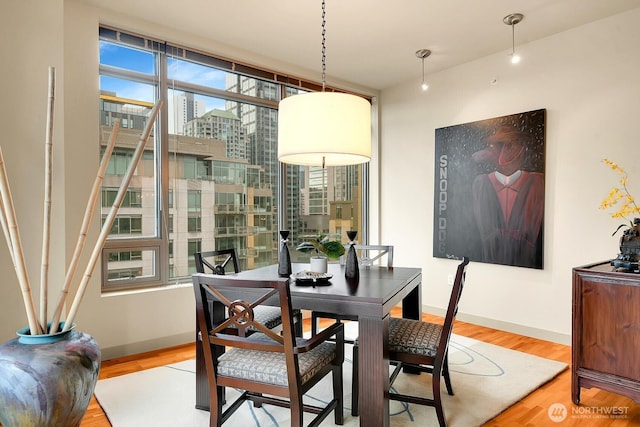 2121 Terry Ave Unit N1203, Seattle, WA 98121 - dining area with wood finished floors, a view of city, and baseboards