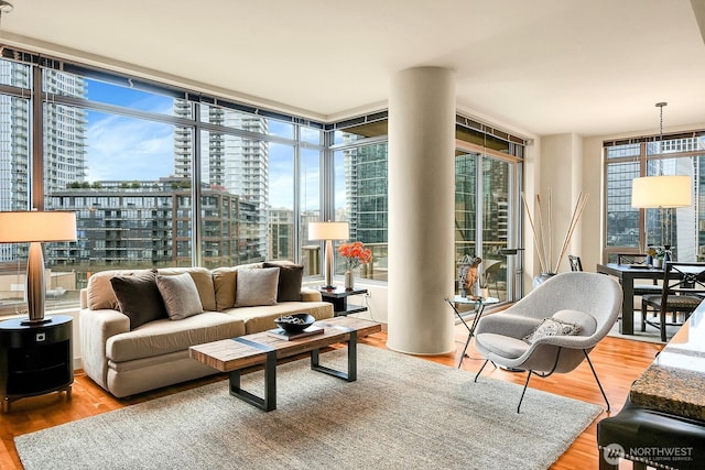 2121 Terry Ave Unit N1203, Seattle, WA 98121 - living room featuring expansive windows, a city view, and wood finished floors