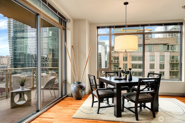 2121 Terry Ave Unit N1203, Seattle, WA 98121 - dining space with wood finished floors and a city view