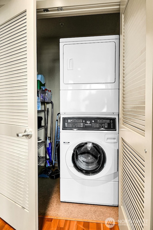 2121 Terry Ave Unit N1203, Seattle, WA 98121 - laundry room featuring stacked washing machine and dryer and wood finished floors