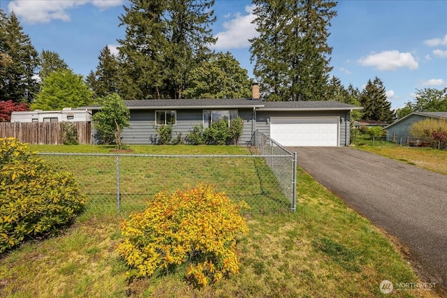 ranch-style home with fence, an attached garage, driveway, a front lawn, and a chimney