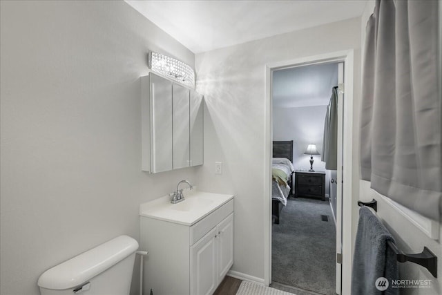 bathroom featuring vanity, toilet, and connected bathroom