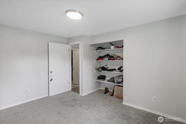 unfurnished bedroom with a closet, baseboards, and carpet floors
