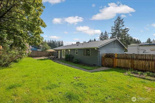 back of house with a lawn, a patio area, and fence