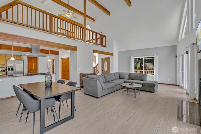 4716 167th Ave NW, Lakebay, WA 98349 - living room featuring high vaulted ceiling, beamed ceiling, a ceiling fan, and baseboards