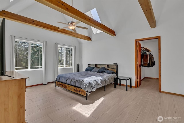 4716 167th Ave NW, Lakebay, WA 98349 - bedroom with beamed ceiling, baseboards, a skylight, high vaulted ceiling, and a walk in closet