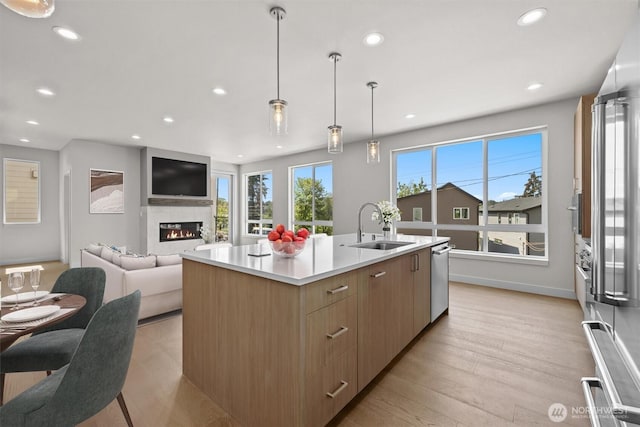 kitchen featuring a sink, open floor plan, modern cabinets, light countertops, and recessed lighting