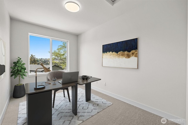 home office with baseboards and carpet floors